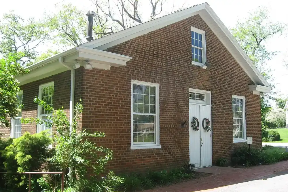 Brick Depreciation Lands Museum building, a former church with white doors, in Allison Park, Pennsylvania