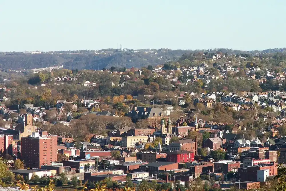 Hillside homes and church towers across the Monongahela River in Munhall and Homestead, Pennsylvania